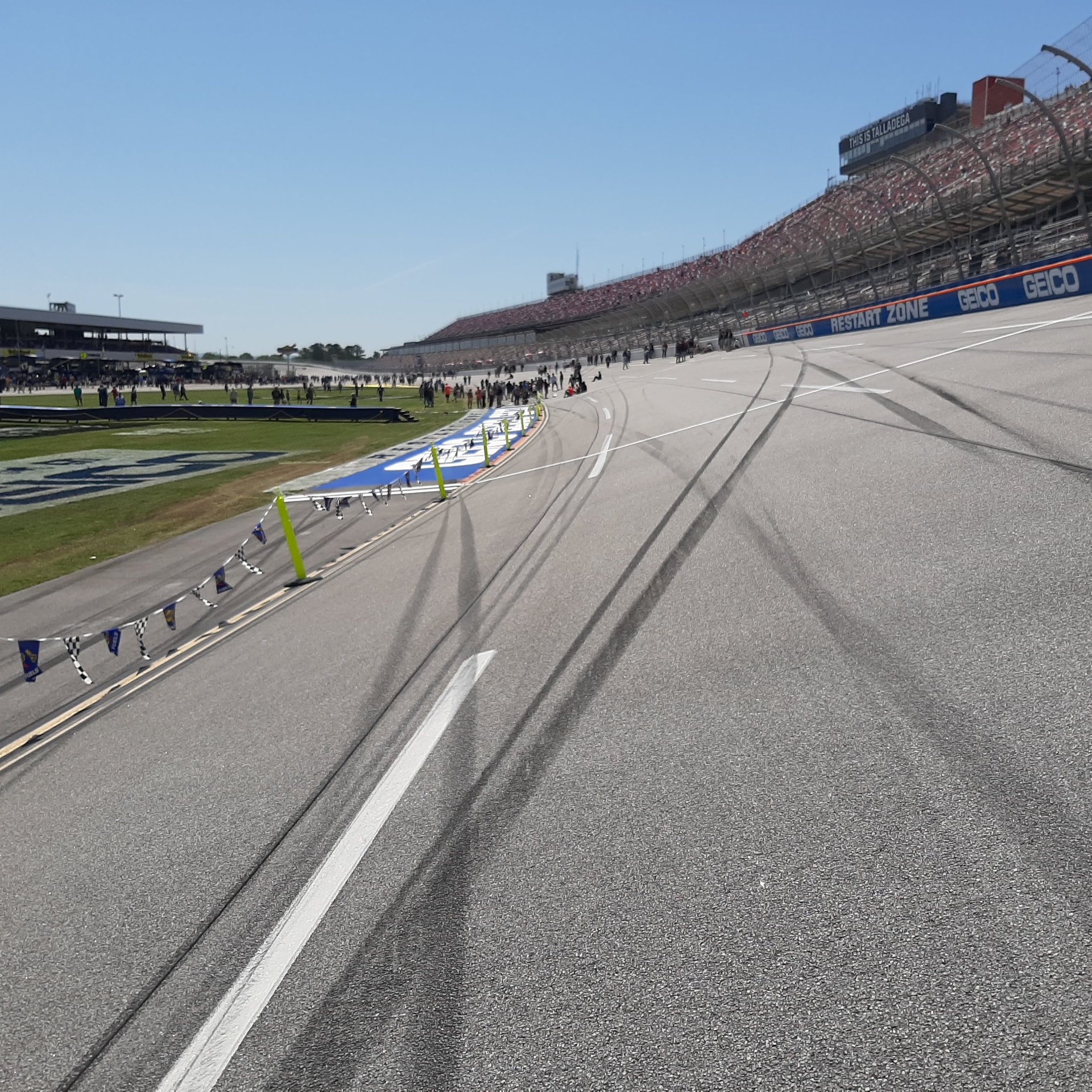 Spectator grandstands beside a banked motor racing track