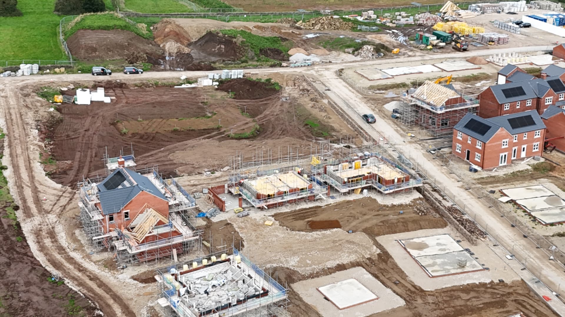 Housing development under construction with scaffolding and site materials