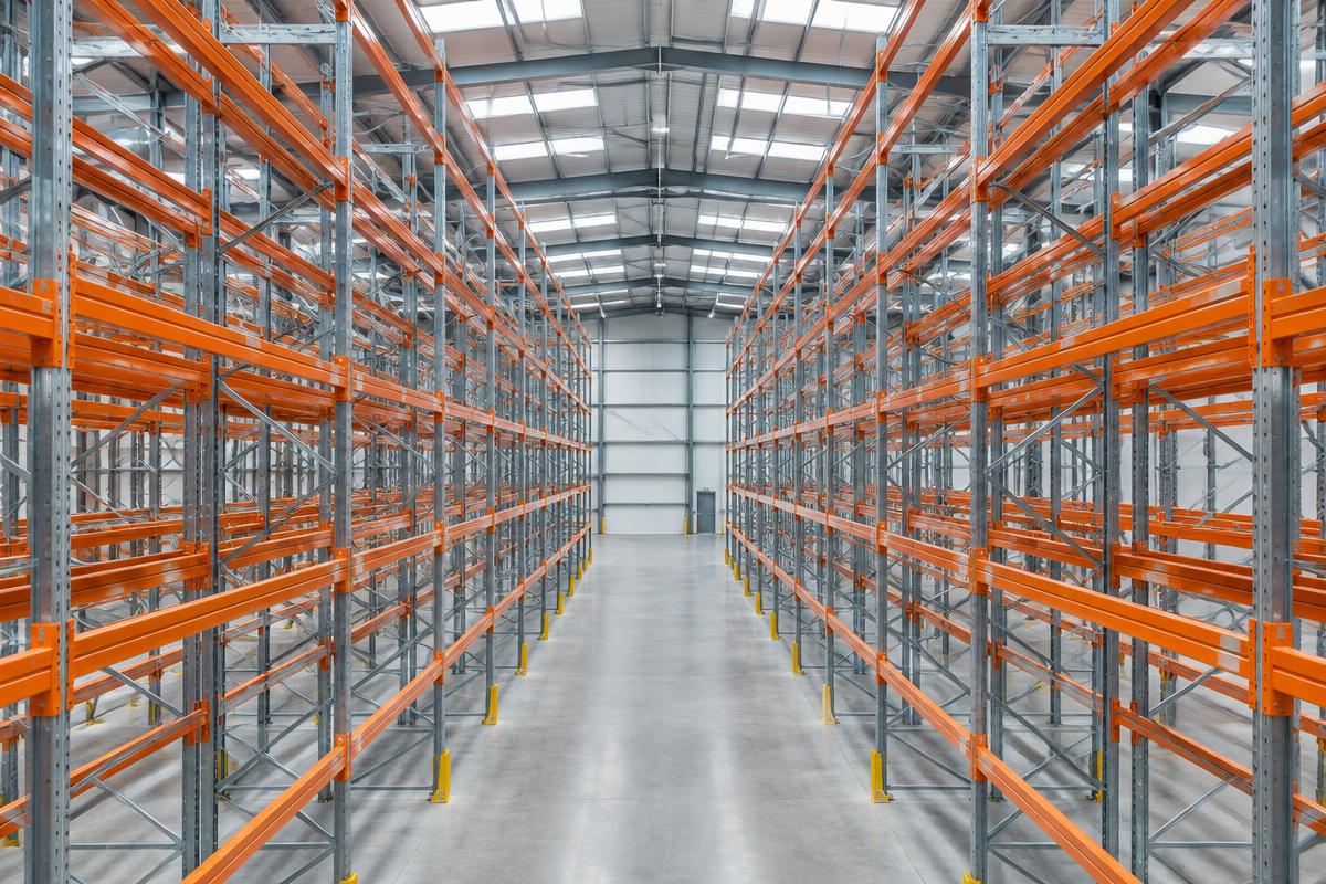 Illustrative view down a high warehouse racking aisle